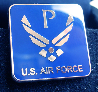 A square, blue, enamel pin says "U.S. Air Force" and has the Air Force logo on it.  The Air Force logo also has the letter "P" on it.