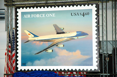 A large replica of a stamp that features an image of Air Force One.  
