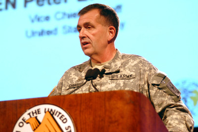 A man in a military uniform stands behind a lectern. The lectern has the words ""Association of the United States Army" and a logo on it.