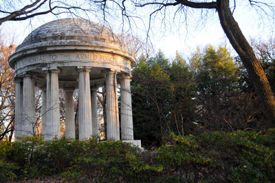 A small rotunda structure stands amidst greenery.  Around the top is says "A memorial to the Armed Forces From..." and then trails off.