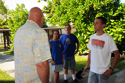 A man talks to several teenagers.