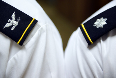 The epaulettes on the shoulders of two military officers display the ranks of colonel and lieutenant colonel.