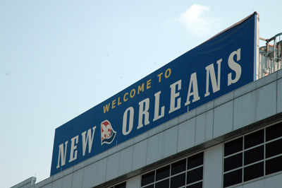 A sign on a building reads "Welcome to New Orleans."