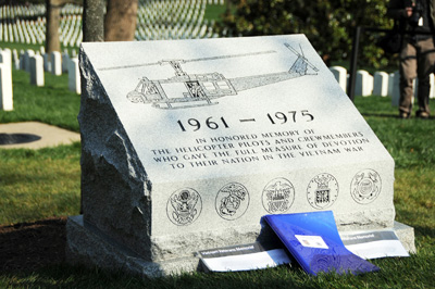 A stone monument is engraved with the image of a  helicopter, the dates "1961-1975," and the words "In honored memory of the helicopter pilots and crew members who gave the full measure of devotion to their nation in the Vietnam War." 