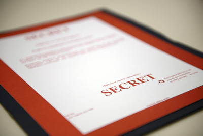 A folder has a cover sheet, printed in red, with the word "Secret" on it.