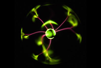 A plasma ball emits green plasma.