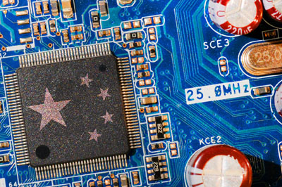 A circuit board features a microchip with the stars of the Chinese flag.